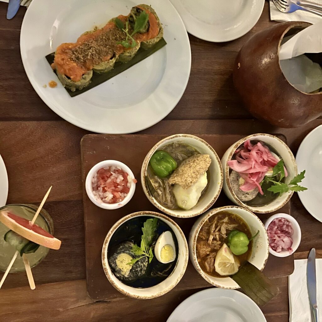 This table displays the food that my friends and I had on our first night in Merida at Museo de la Gastronomía Yucateca. I wasn't too fond of the appetizer, a sliced tamal dish described below. Next to this dish is a platter containing four Yucatecan dishes and a cocktail with a grapefruit garnish.