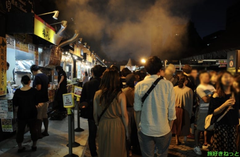 Many people and stalls at night at Sapporo Autumn Fest