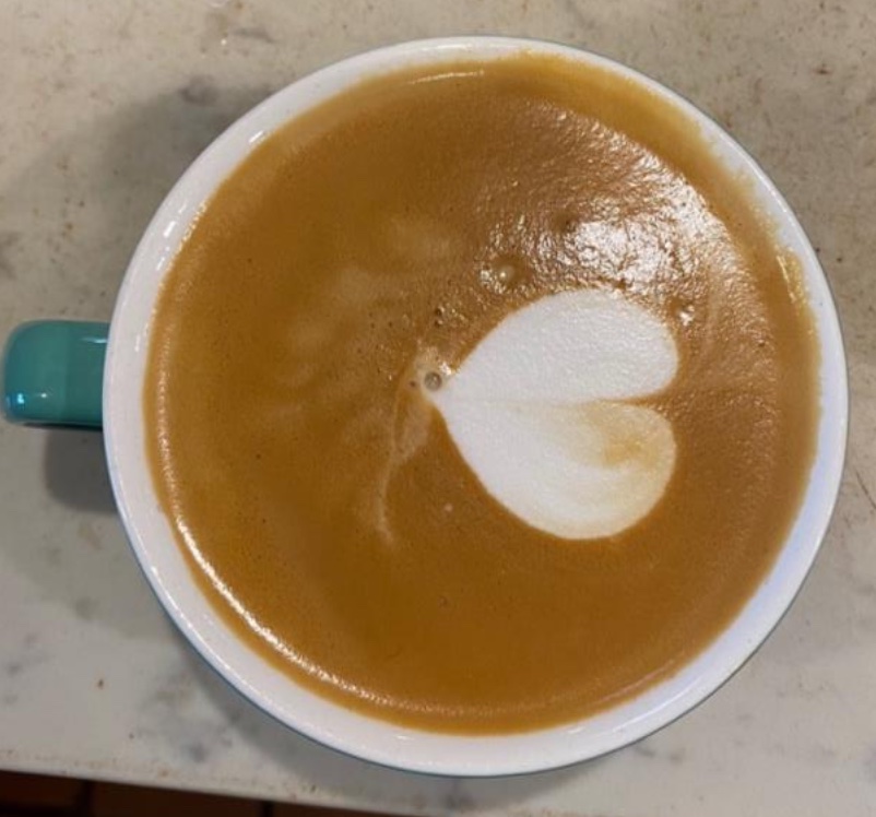 Coffee mug with a simple heart latté art done by me with professional barista equipment and whole milk.