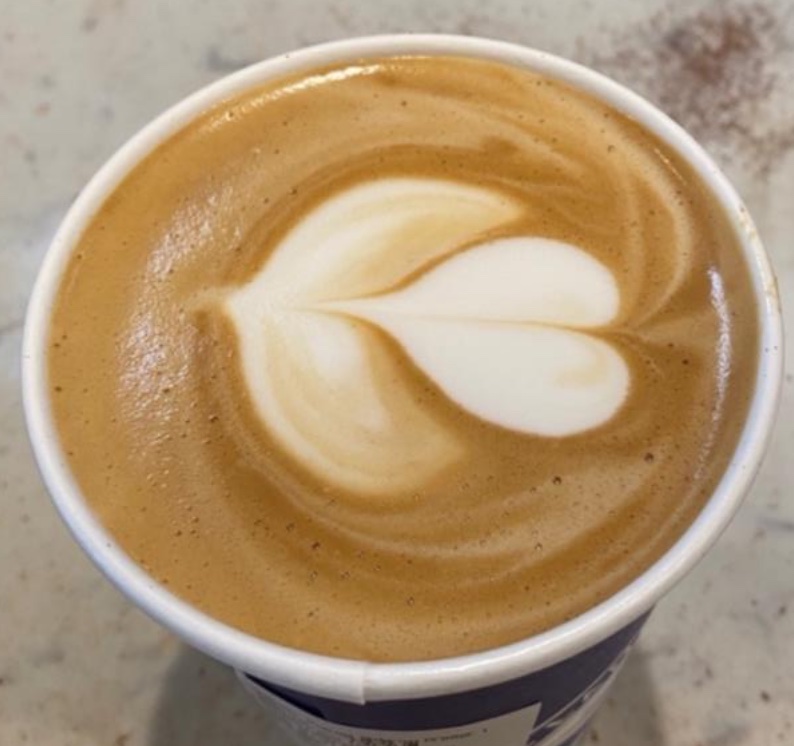 To-go coffee cup with 2-layer tulip latté art done by me with professional barista equipment and whole milk.