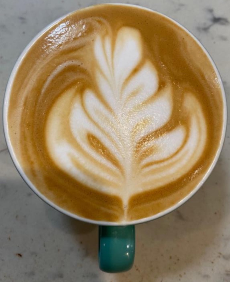 Coffee mug with rosetta latté art done by me with professional barista equipment and whole milk.