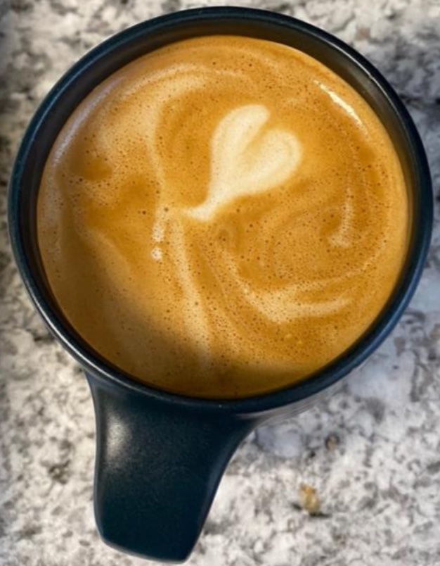 Mug with very small heart latté art done by me with at-home equipment and oat milk.